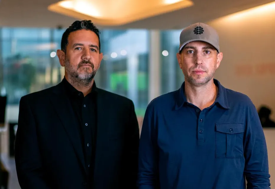 Limbik co-founders Zach Schwitzky and Josh Levin standing together in an office.
