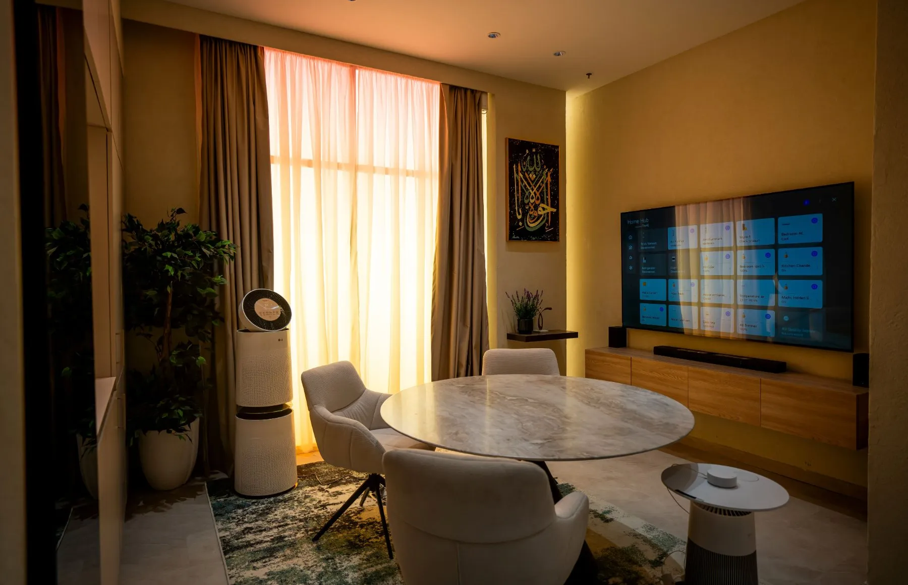 Living area at LG’s AI Home Experience Zone in Riyadh with a TV displaying the smart-home control dashboard and connected appliances.