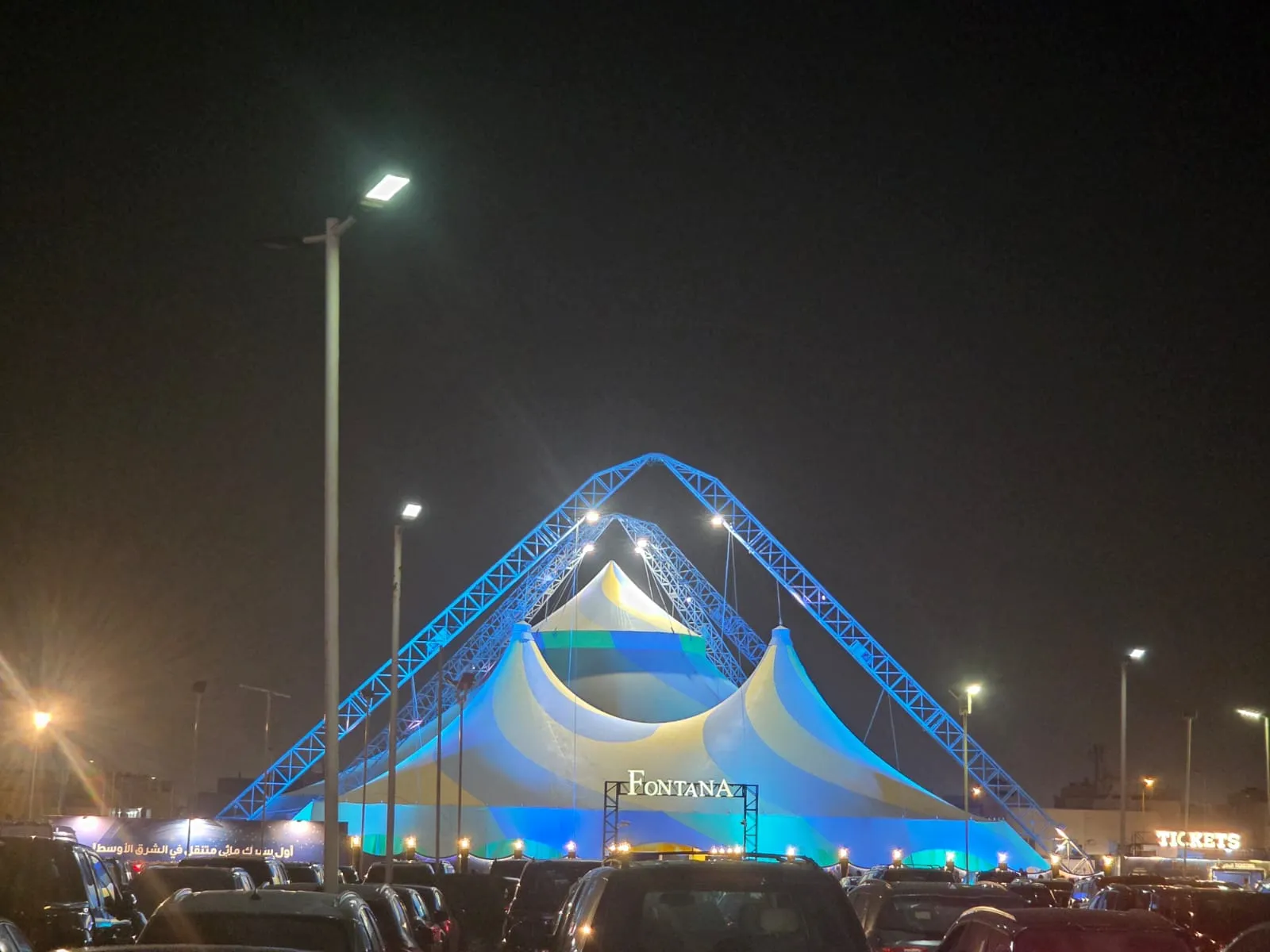 Fontana Circus tent illuminated at night beside the parking area at Nakheel Mall in Riyadh