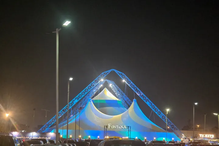Fontana Circus tent illuminated at night beside the parking area at Nakheel Mall in Riyadh