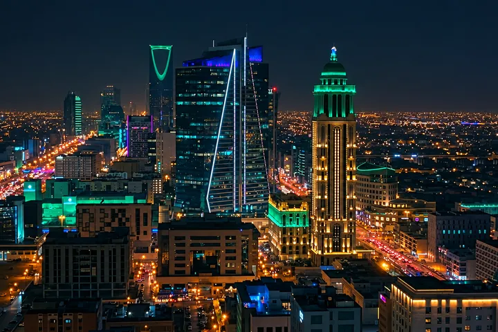 Riyadh skyline at night, with illuminated towers and roads; edited photograph by Saif Al Dhaher.