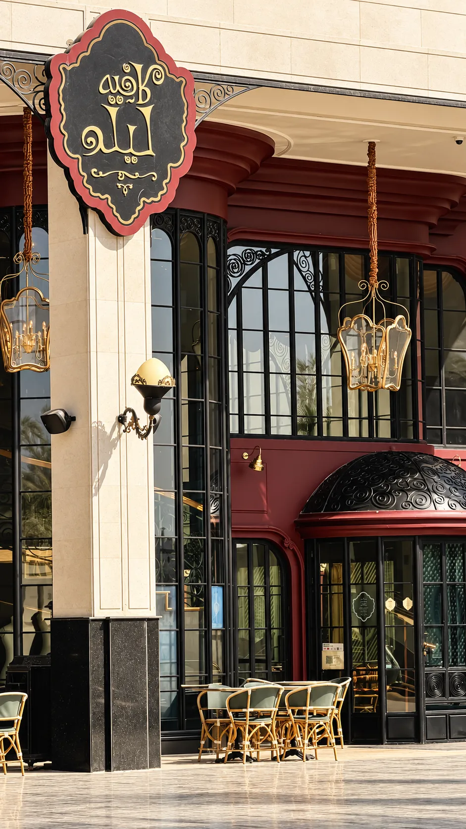 A Riyadh cafe entrance with decorative lanterns and outdoor seating.