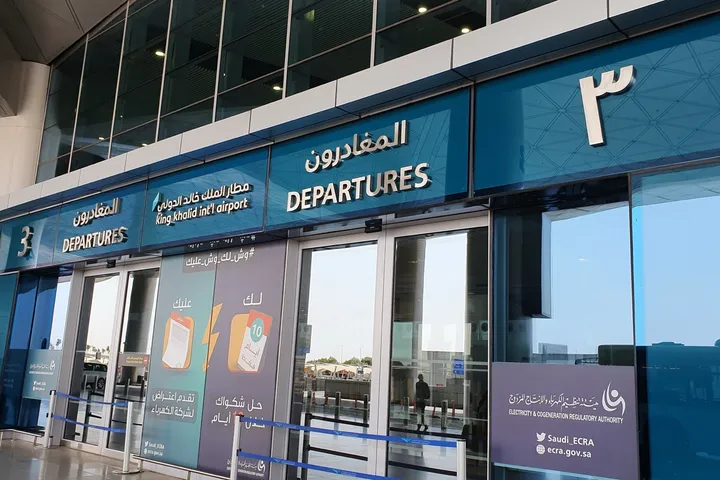 Blue departures entrance and Terminal 3 signage at King Khalid International Airport in Riyadh