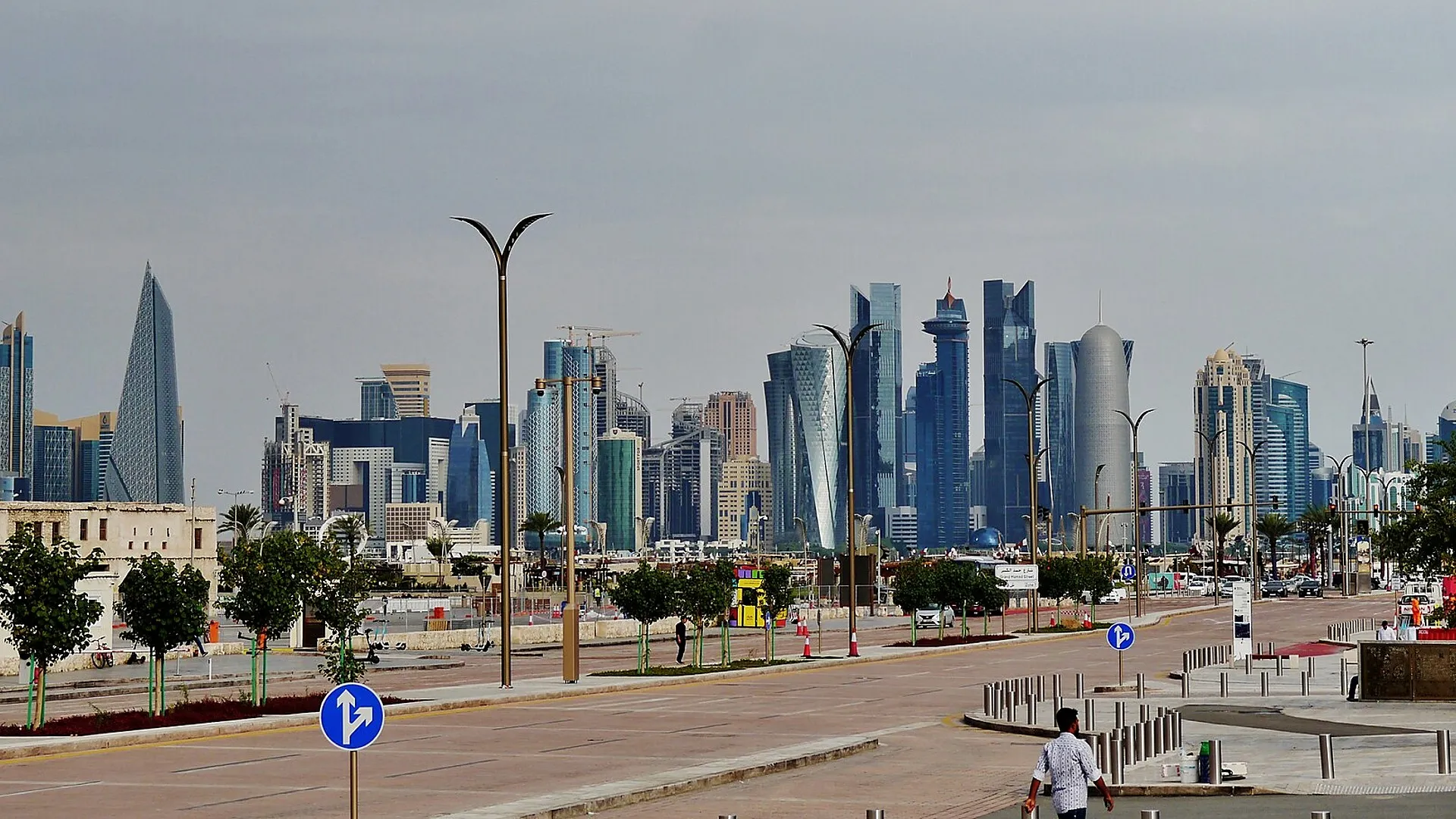 Doha’s West Bay skyline beyond a broad city road, photographed from the Corniche area.