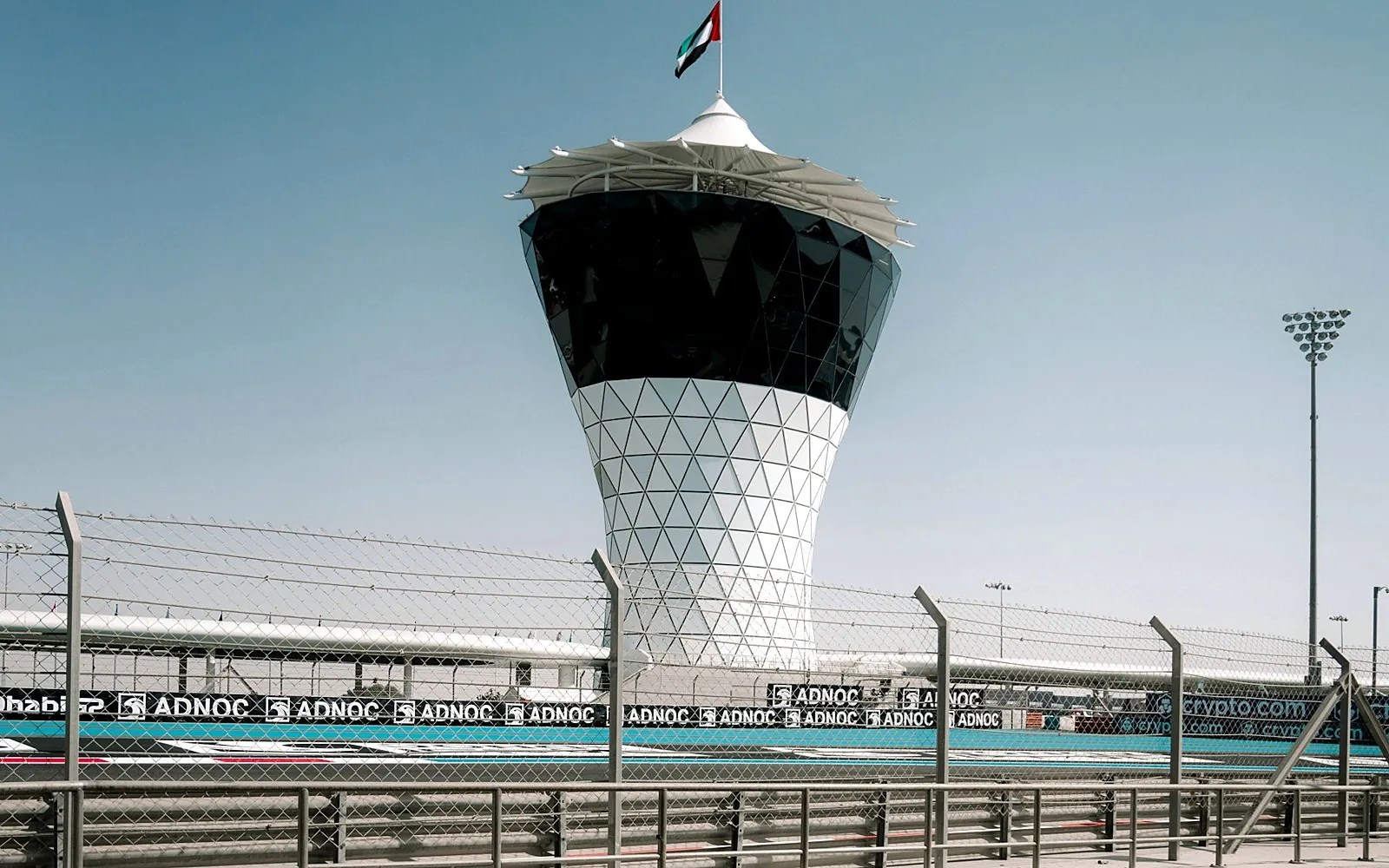 Yas Marina Circuit tower and track behind safety fencing